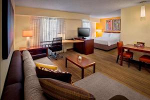 a hotel room with a couch and a bed and a desk at Sonesta ES Suites Allentown Bethlehem Airport in Allentown