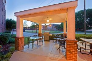 a pavilion with tables and chairs on a patio at Sonesta Simply Suites Arlington in Arlington