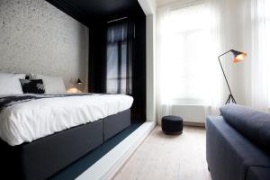 Postel nebo postele na pokoji v ubytování Maison Nationale City Flats & Suites