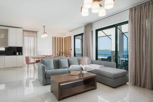 a living room with a couch and a table at Elia Penthouse in Chania Town