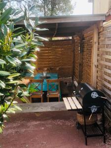 a patio with a table and chairs and a bench at la ferme de manu in Saulxures