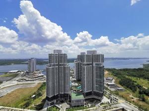 two tall buildings in a city next to a body of water at C0509 MUJI STYLE STUDIO Almas 100mbps Pool View Netflix By STAY in Nusajaya