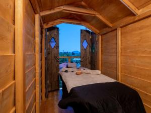 a bedroom with a bed in a wooden cabin at Dorothea Villa in Zakynthos Town