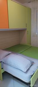 a bunk bed in a room with green and orange at Casa Marietta in Polignano a Mare