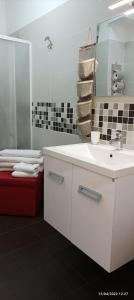 a bathroom with a white sink and a mirror at Casa Marietta in Polignano a Mare