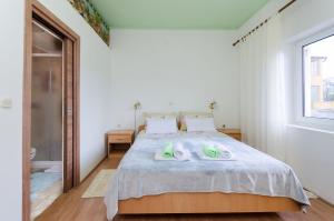 Postel nebo postele na pokoji v ubytování Apartments Mijatovic