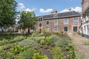 a garden in front of a brick building at Boutique Hotel Rijks I Kloeg Collection in Goes