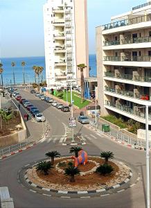 a city street with a building and a road with cars at Luxury Aparment 5 room 2 minutes from the beach in Bat Yam
