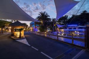 a view of a street at night with buildings at Camping Les Sables d'Or in Cap d'Agde