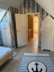 a room with a bed and a rug on the floor at Ferienhaus Nordseejuwel in Friedrichskoog-Spitze +31 photos