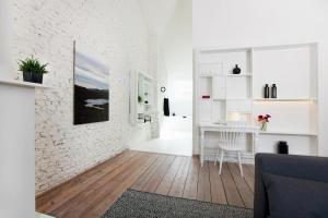 a white living room with a white brick wall at Maison Nationale City Flats & Suites in Antwerp
