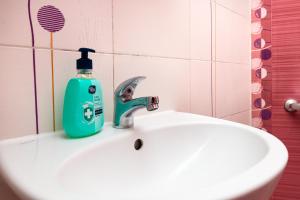 a green soap bottle sitting on top of a white sink at Lovely 1BD Apartment close to the Summer Theatre by Flat Mаnager in Plovdiv +16 photos