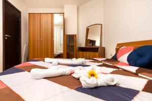 a room with three beds with towels on them at Lovely 1BD Apartment close to the Summer Theatre by Flat Mаnager in Plovdiv