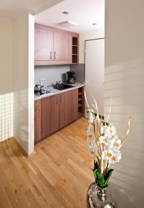 a kitchen with a vase with white flowers in it at GuestHouse Mannheim in Mannheim