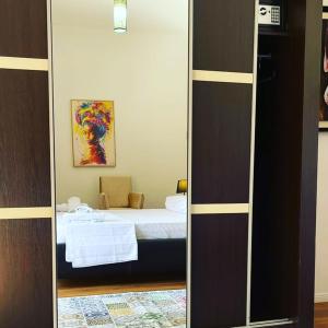 a mirror of a bedroom with a bed in a room at Hotel Ambasador in Lezhë