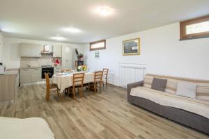 a living room with a table and a bed and a kitchen at Modern apartment with 2 bedrooms Casa Perla by VacaVilla in Camaiore