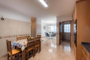 a kitchen and dining room with a table and chairs at Sunnyside Villa in Arco da Calheta