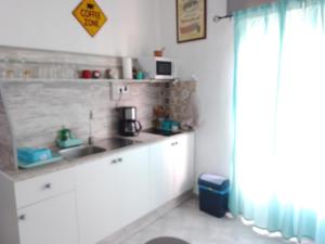 a small kitchen with a sink and a window at Bella Vista in Almería