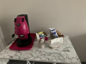 a pink mixer sitting on top of a counter at house231 in Manduria