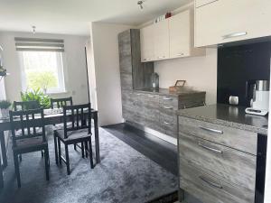 a kitchen with a table and chairs in a room at Family house in Jurmala in Jūrmala