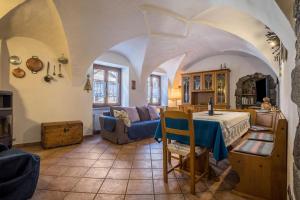 a living room with a table and a couch at Appartamento Jasmine in Molina di Ledro