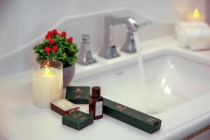a bathroom counter with a sink with a candle and soap at ANIM Boutique Hotel in Denizli +30 photos
