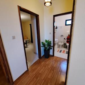 a hallway leading to a bathroom with a toilet at Chalé Seixal - Sea View in Seixal