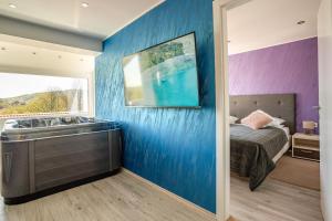 a bedroom with a bathtub in the corner of a room at Deluxe Apartments Franjkovic in Seliste Dreznicko