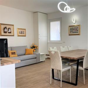 a living room with a couch and a table at GIORNI FELICI: appartamento tutto nuovo, giardino, parcheggio in Verbania