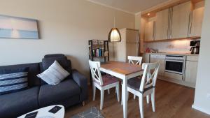 a living room with a table and a couch at NordseeGlück in Cuxhaven +23 photos
