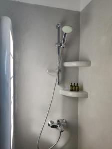 a shower in a bathroom with a sink at Aeraki in Kithnos