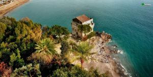 an island with a house on top of the water at Casa Colombo in Vietri sul Mare