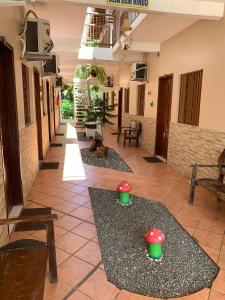 a hallway with red and green mushrooms on the floor at Pousada Igarapé in Barreirinhas