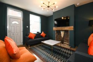 a living room with a couch and a fireplace at Cottage Style 3 bedroom House - Close to City centre & The Peaks in Chesterfield