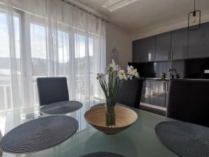 a kitchen with a table with a vase of flowers on it at DreamHouse in Jajce