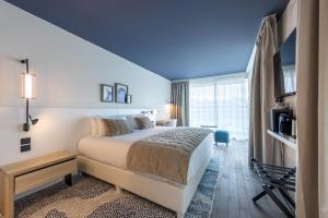 a hotel room with a bed and a window at Hotel Indigo Cagnes-sur-Mer by IHG in Cagnes-sur-Mer