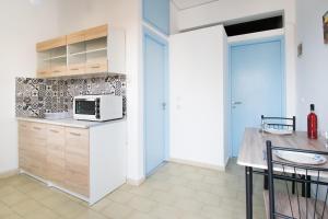 a kitchen with a counter and a microwave in it at CHAMBRE BLANCHE in Ialysos
