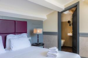a hotel room with a bed and a mirror at Hotel Castellino Roma in Rome