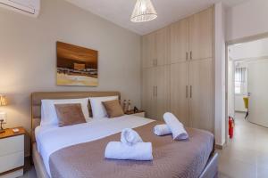 Ένα ή περισσότερα κρεβάτια σε δωμάτιο στο Gouves Living +37 φωτογραφίες