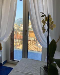 a room with a window with a view of a balcony at Casa Blu Cobalto in Maiori