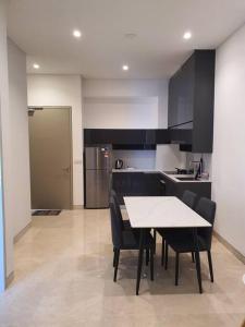 a kitchen with a table and chairs in a room at Infinity pool/LUCENTIA BBCC,near TRX, KLCC, PNB118 in Kuala Lumpur