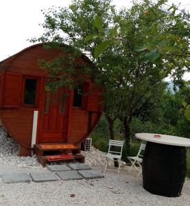 a large wooden cabin with a table and chairs at Agriturismo Rossolampone in Gerano