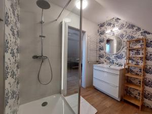 a bathroom with a shower and a tub and a sink at Beztroska Chata Bieszczady in Mchawa