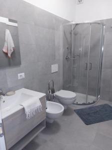 a bathroom with a shower and a toilet and a sink at Casa Marica - Appartamento nel Borgo di Pieve in Tremosine Sul Garda