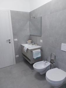 a bathroom with a white toilet and a sink at Casa Marica - Appartamento nel Borgo di Pieve in Tremosine Sul Garda