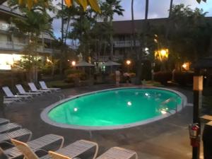 a swimming pool with lounge chairs around it at GARDEN VIEW STUDIO - KONA ISLANDER INN CONDOS condo in Kailua-Kona
