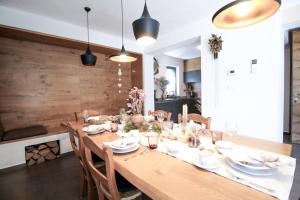 a dining room with a wooden table and chairs at Apartments ALPA VITA in Kobarid