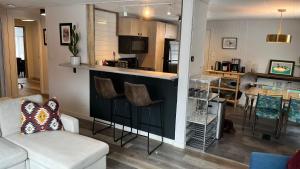 a kitchen and living room with a bar in a house at Newly Remodeled Lakefront Cottage in Three Lakes in Three Lakes