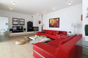 a living room with red furniture and a red couch at Villa Napa Seaside in Ayia Napa