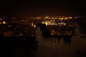 a view of a city at night at Moroccan Dream Hostel in Fez
